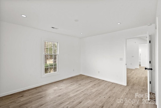 spare room featuring light wood-type flooring