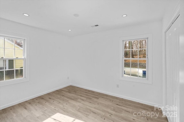 spare room featuring light hardwood / wood-style floors