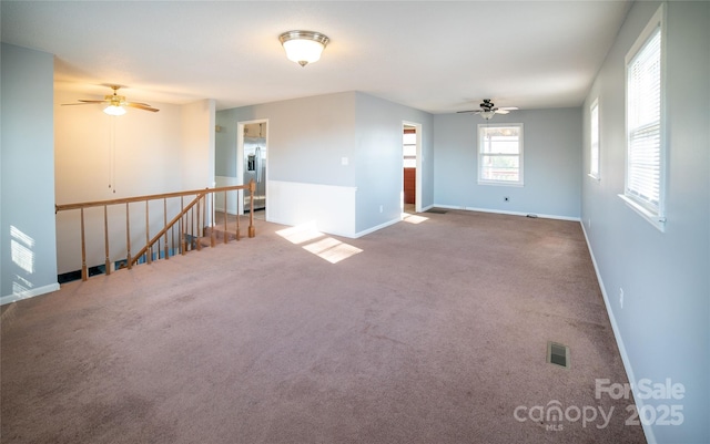 unfurnished room with ceiling fan and carpet floors