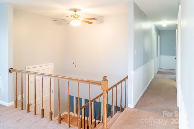 hallway featuring light colored carpet