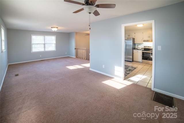 unfurnished room with light carpet and ceiling fan