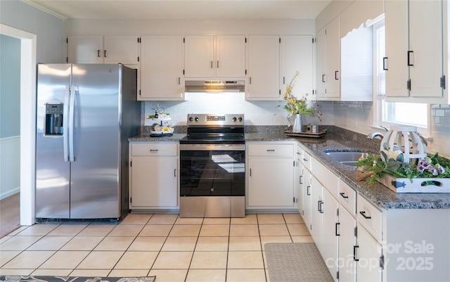 kitchen featuring white cabinetry, appliances with stainless steel finishes, and dark stone counters