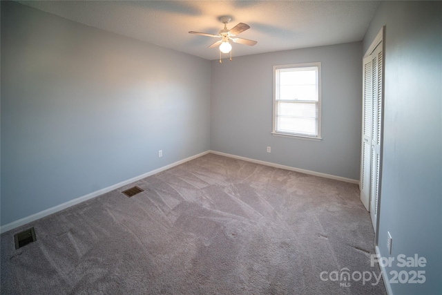 carpeted empty room with ceiling fan