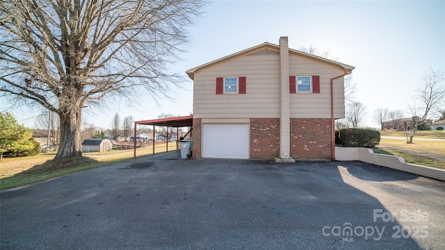 view of side of property featuring a carport and a garage