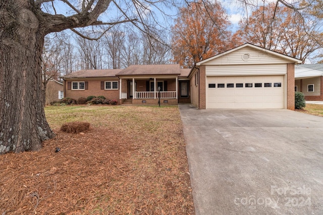 ranch-style home with a garage, a porch, and a front yard