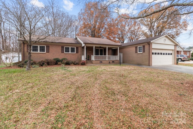 ranch-style home featuring a front lawn, covered porch, and a garage