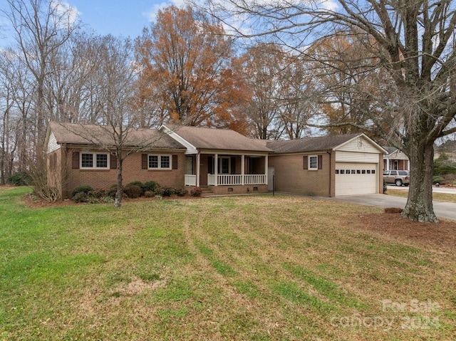 ranch-style house featuring covered porch, a garage, and a front lawn