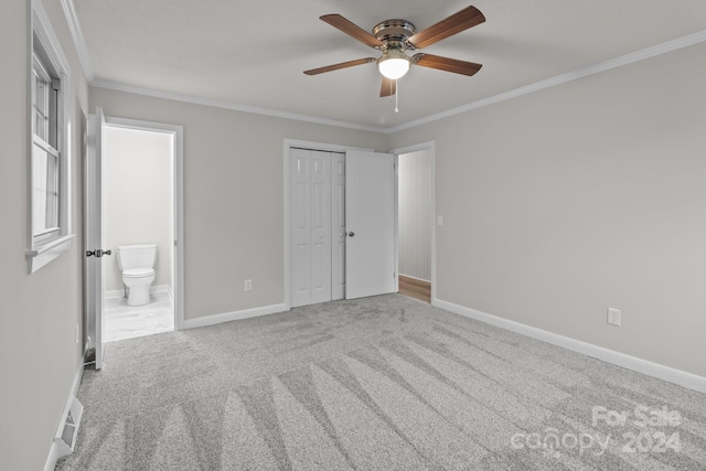 unfurnished bedroom with carpet, ornamental molding, ceiling fan, connected bathroom, and a closet