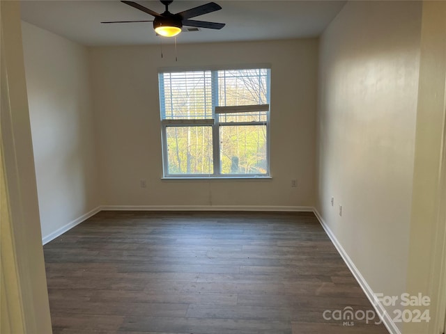 spare room featuring ceiling fan and dark hardwood / wood-style flooring