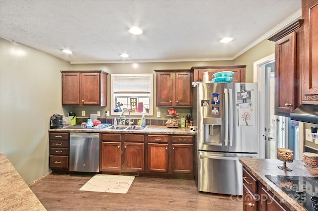 kitchen with sink, ornamental molding, stainless steel appliances, and dark wood-type flooring