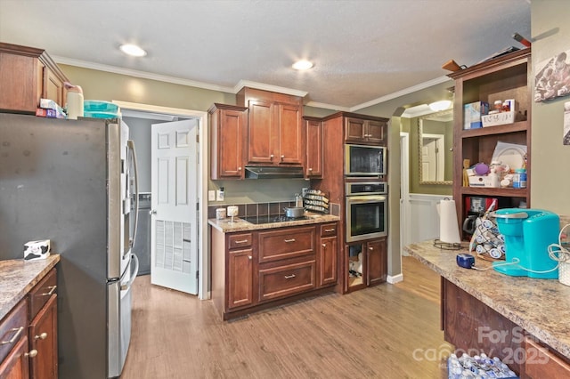 kitchen featuring light stone counters, ornamental molding, light wood-type flooring, and appliances with stainless steel finishes