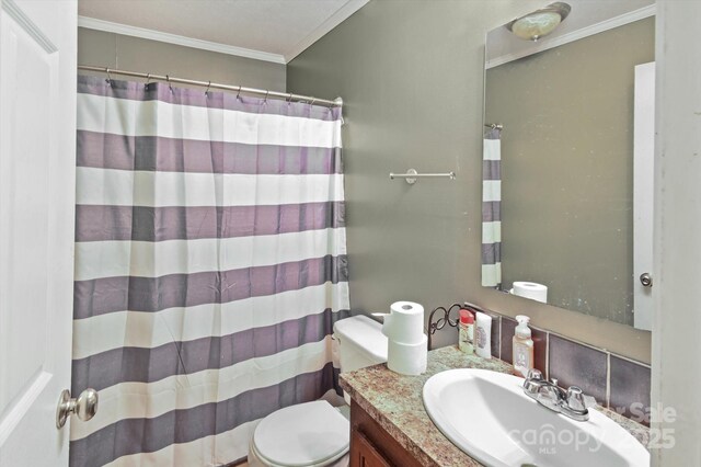 bathroom with crown molding, vanity, a shower with shower curtain, and toilet