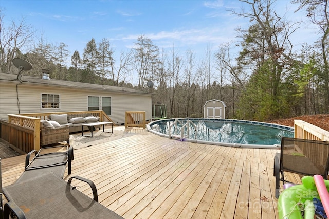 view of swimming pool with an outdoor living space and a deck