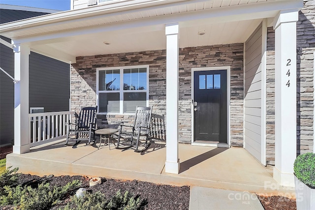 entrance to property featuring a porch