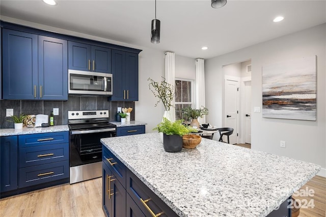 kitchen featuring a center island, blue cabinets, light hardwood / wood-style floors, decorative backsplash, and appliances with stainless steel finishes