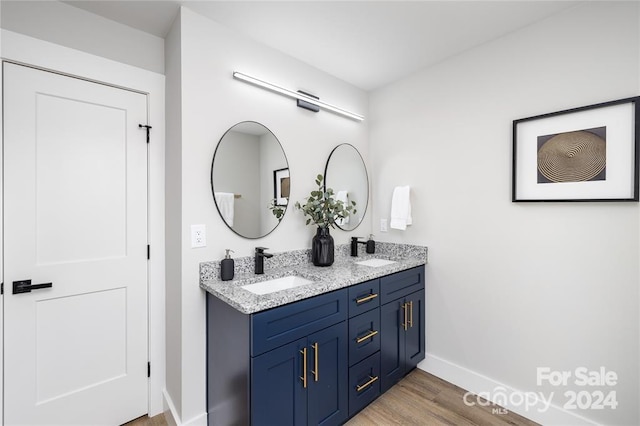 bathroom with vanity and hardwood / wood-style flooring