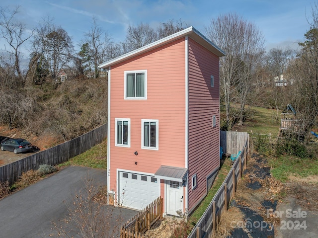 view of property exterior with a garage