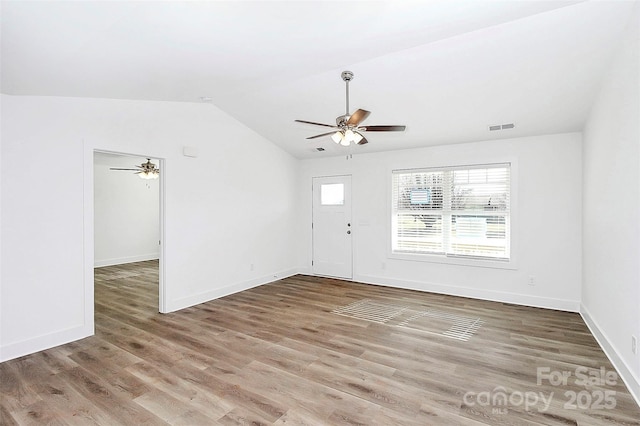 interior space with ceiling fan, wood-type flooring, and lofted ceiling