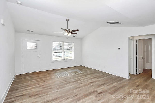 unfurnished living room featuring lofted ceiling, hardwood / wood-style flooring, and ceiling fan