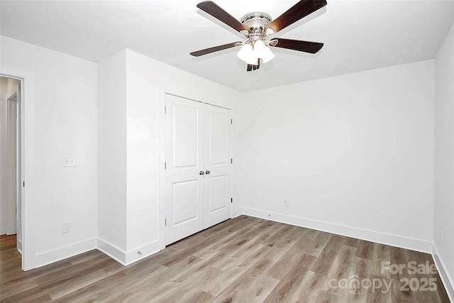 unfurnished bedroom with ceiling fan, a closet, and light hardwood / wood-style flooring