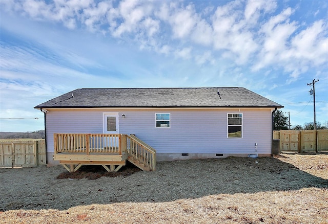 back of house with a deck