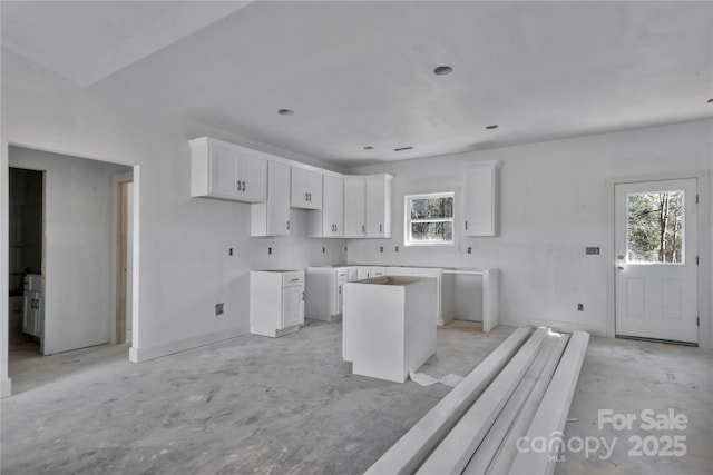 kitchen featuring plenty of natural light, white cabinetry, and a center island