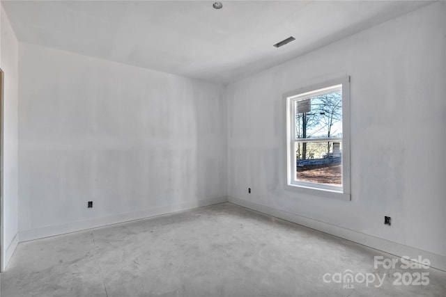 unfurnished room with concrete floors