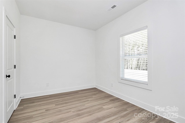 unfurnished bedroom with light wood-style flooring, baseboards, and visible vents