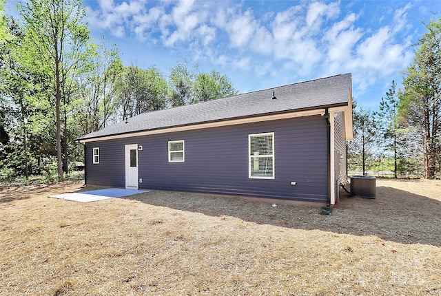 back of house featuring cooling unit
