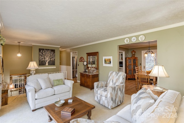 living room with light carpet, a textured ceiling, an inviting chandelier, and ornamental molding