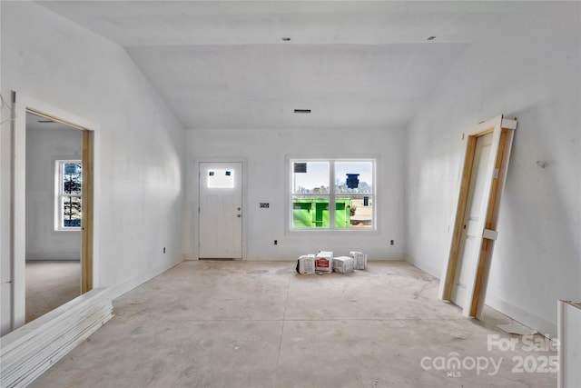 foyer entrance featuring vaulted ceiling