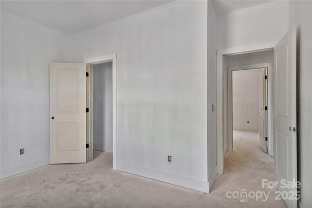 unfurnished room with baseboards