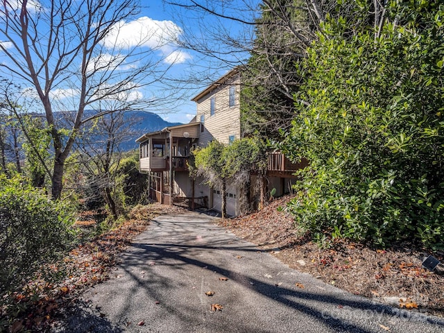 exterior space featuring a deck with mountain view and a garage