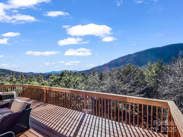 wooden deck with a mountain view