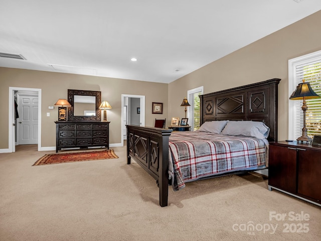 bedroom featuring multiple windows and light carpet