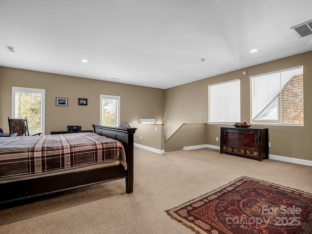 bedroom featuring light carpet and multiple windows