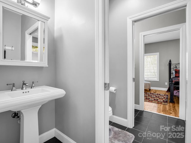 bathroom featuring tile patterned floors, toilet, and sink