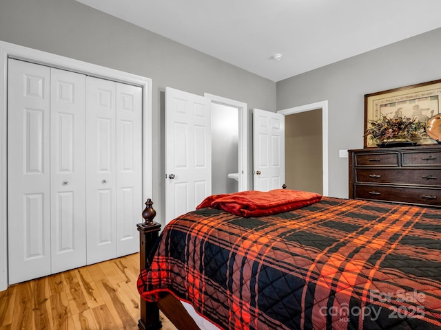 bedroom with light hardwood / wood-style flooring and a closet