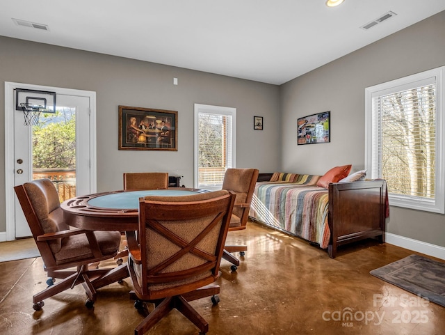 dining space featuring concrete flooring and a wealth of natural light