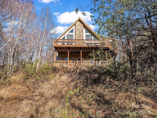 back of house featuring a wooden deck