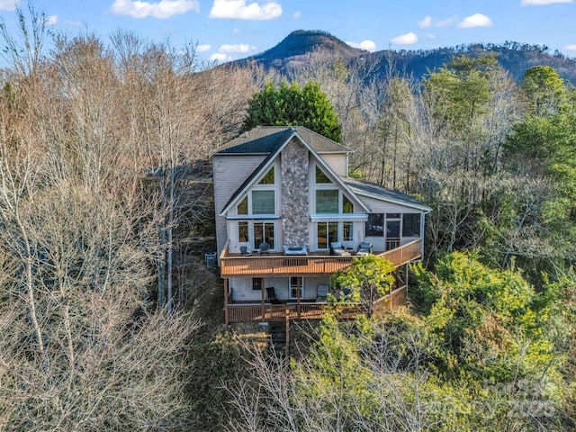 rear view of property with a deck with mountain view