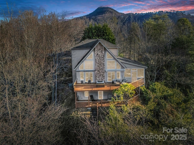 back house at dusk with a mountain view