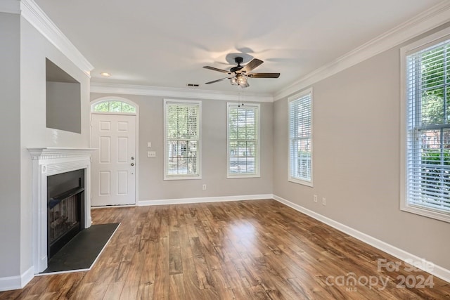 unfurnished living room with ceiling fan, wood-type flooring, and ornamental molding