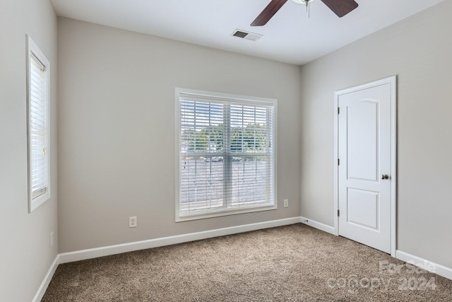 unfurnished room with ceiling fan and carpet floors