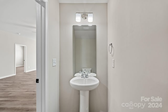 bathroom with hardwood / wood-style flooring