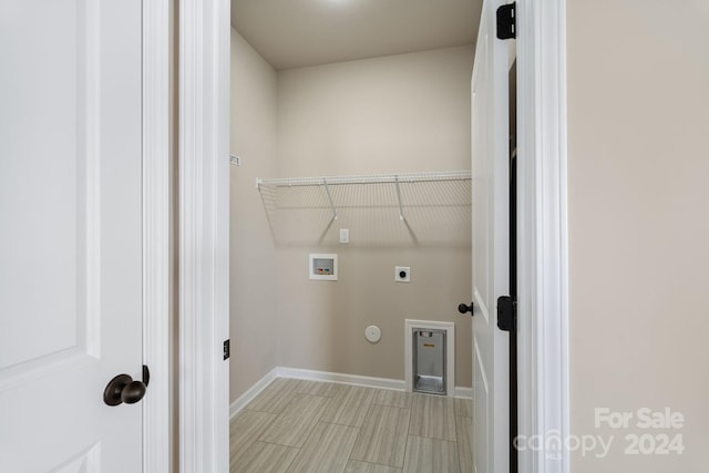 clothes washing area featuring hookup for an electric dryer, gas dryer hookup, and hookup for a washing machine