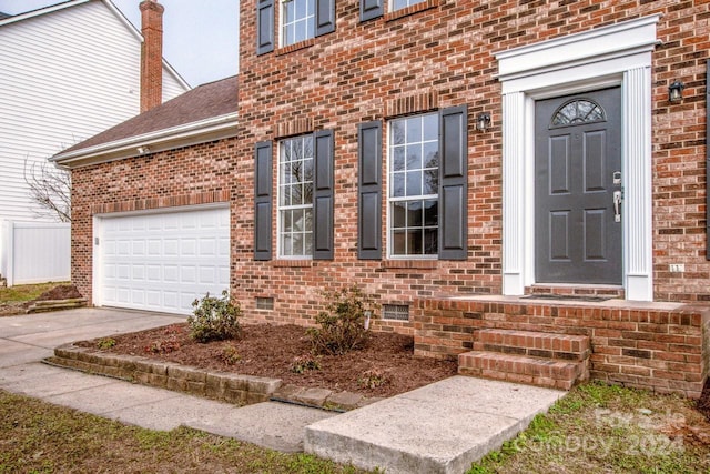 doorway to property featuring a garage