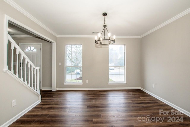 unfurnished dining area featuring dark hardwood / wood-style flooring, ornamental molding, and a chandelier