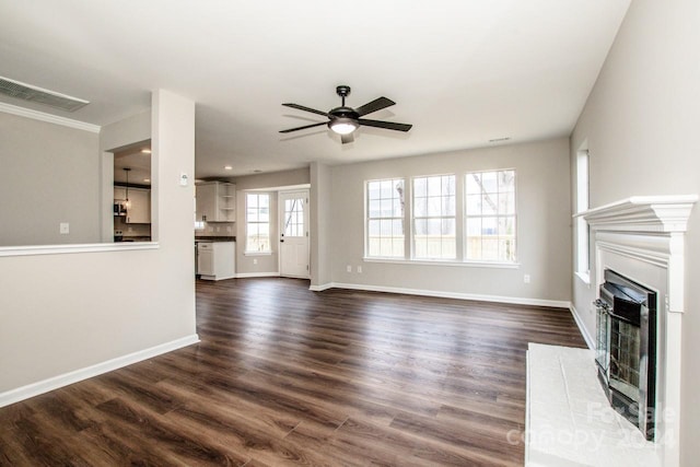 unfurnished living room with dark hardwood / wood-style floors and ceiling fan