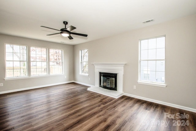 unfurnished living room featuring dark hardwood / wood-style floors and ceiling fan